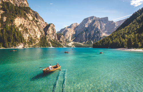 Boat on clear water with mountains in background