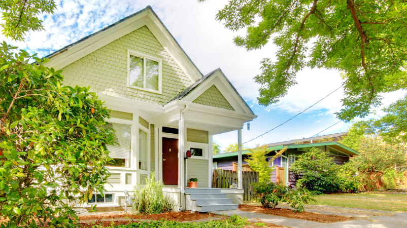 craftsman style home with trees beside it