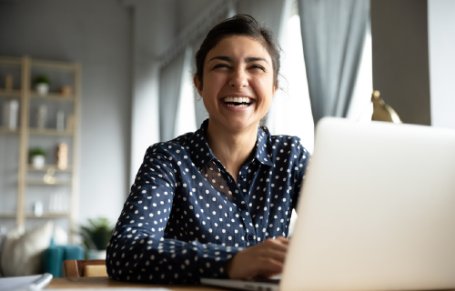 laughing woman using laptop